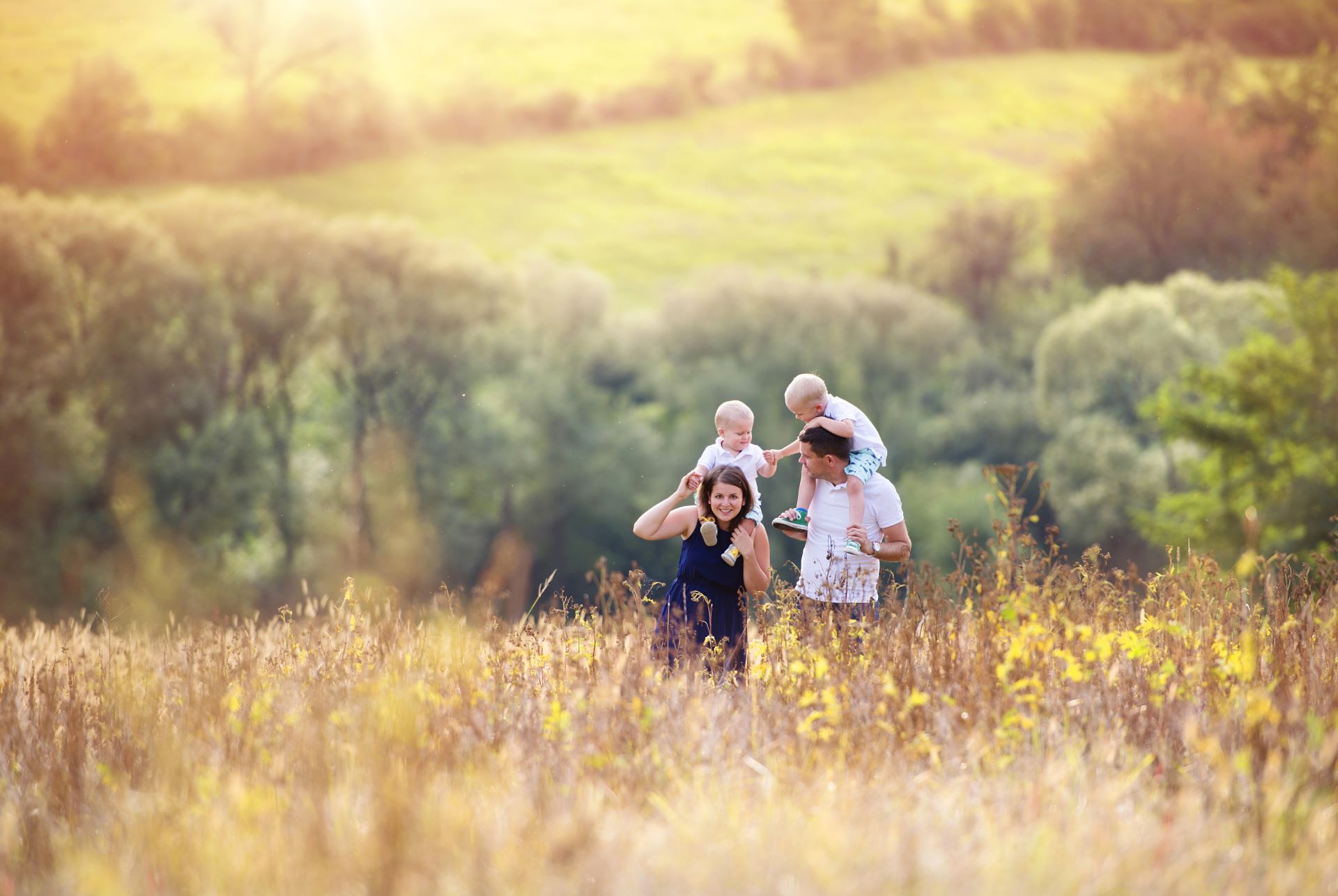 a family walking through a field in spring time