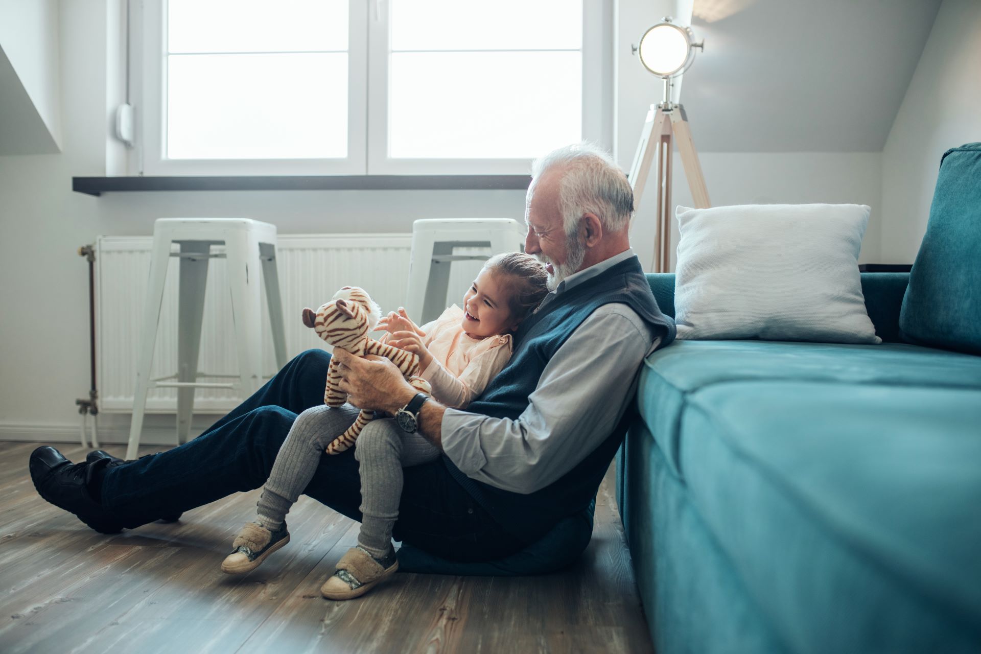 a grandfather playing with his granddaughter