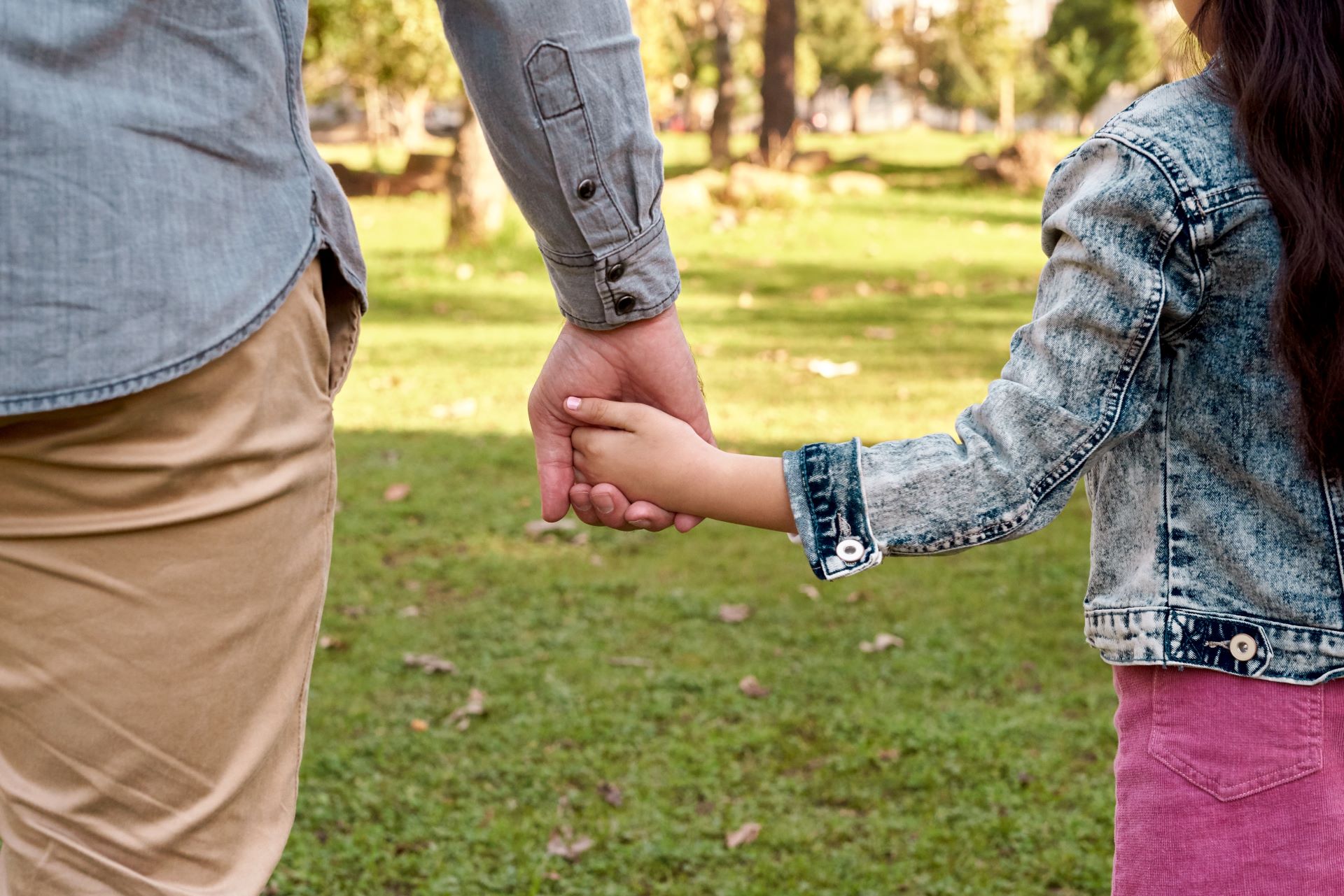 a parent and child holding hands